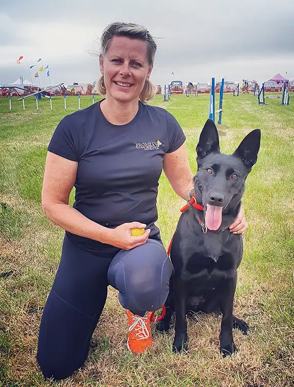 sharon arnold at an event with her dutch shepherd dog